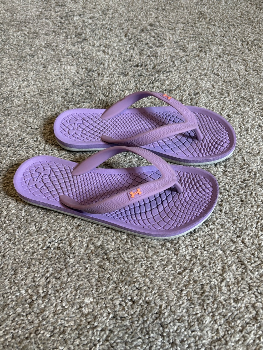 Big kids under Armour flip-flops